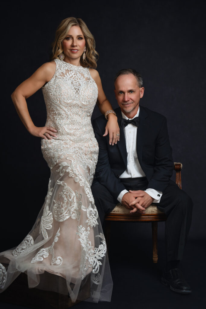 Formal couple portrait with woman in lace gown and man in tuxedo, photographed by Breanne Cook of Breanne Fine Portraiture Birmingham AL.