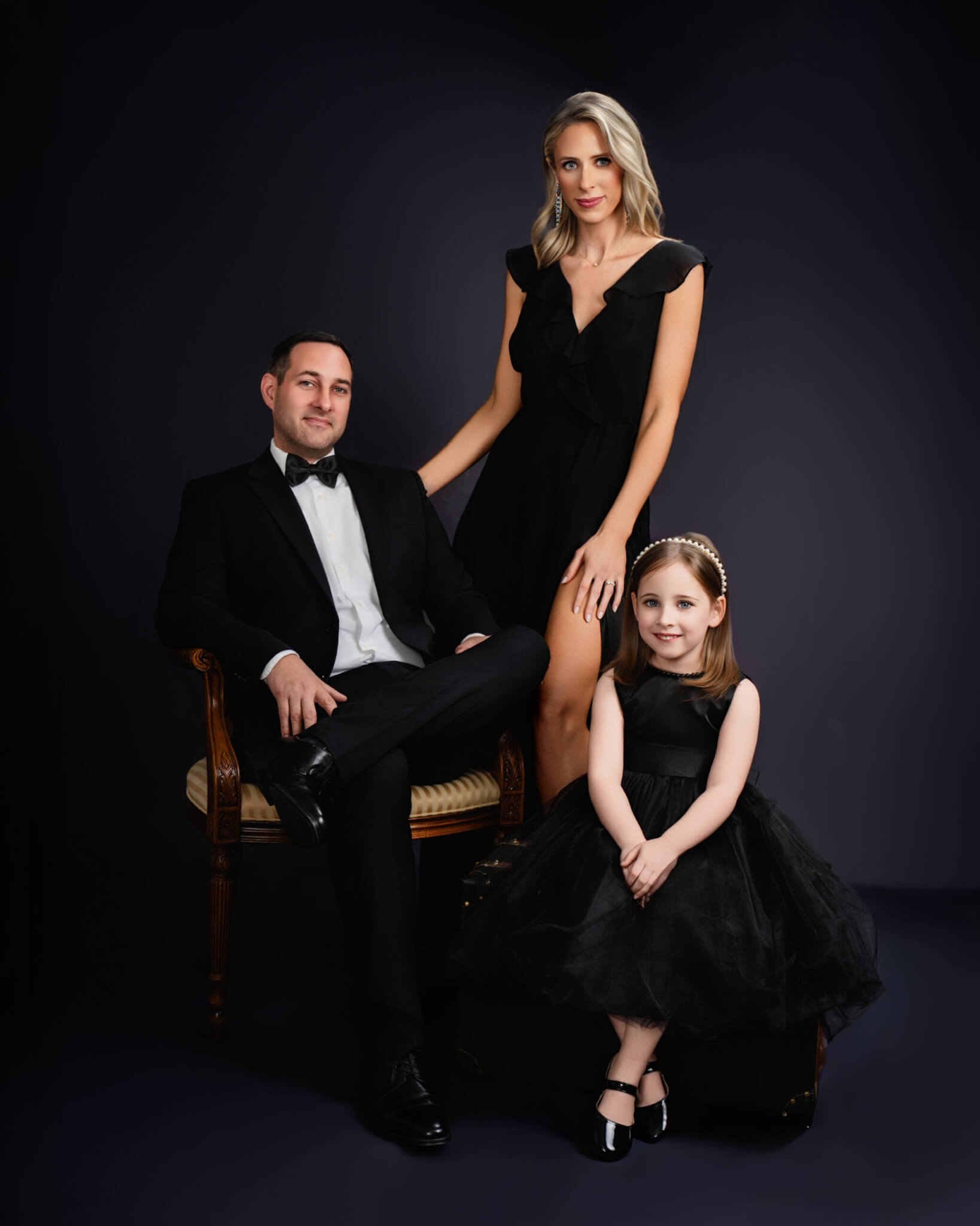 Luxury family portrait in black formal outfits, child in tulle dress, Birmingham studio