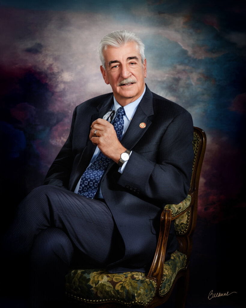 Commissioner Joe Knight seated portrait — dignified lighting and classic fine art composition.