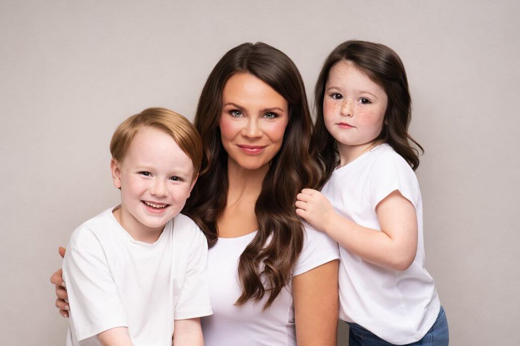 Mother with her freckled son and daughter in white T-shirts and jeans for a simple editorial family portrait in Birmingham, Alabama