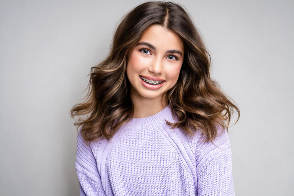 Young girl smiling with braces during her age-appropriate modeling portfolio session with headshot photographer Breanne Cook of Breanne Fine Portraiture in Birmingham Alabama