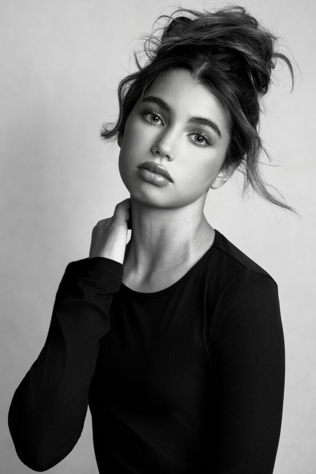 Black-and-white portrait of a young girl modeling an all-black outfit during a modeling portfolio photography session with Breanne Cook of Breanne Fine Portraiture in Birmingham Alabama